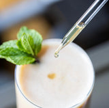 Image thumbnail: A close-up shows a creamy drink with mint as a North Spore Mind & Body Mushroom Tincture Variety Pack (Small) is dropped in above the surface.