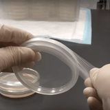 Image thumbnail: Gloved hands using parafilm to seal a petri dish