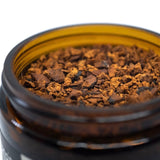 Image thumbnail: Close up of ground chaga mushroom wellness tea in jar