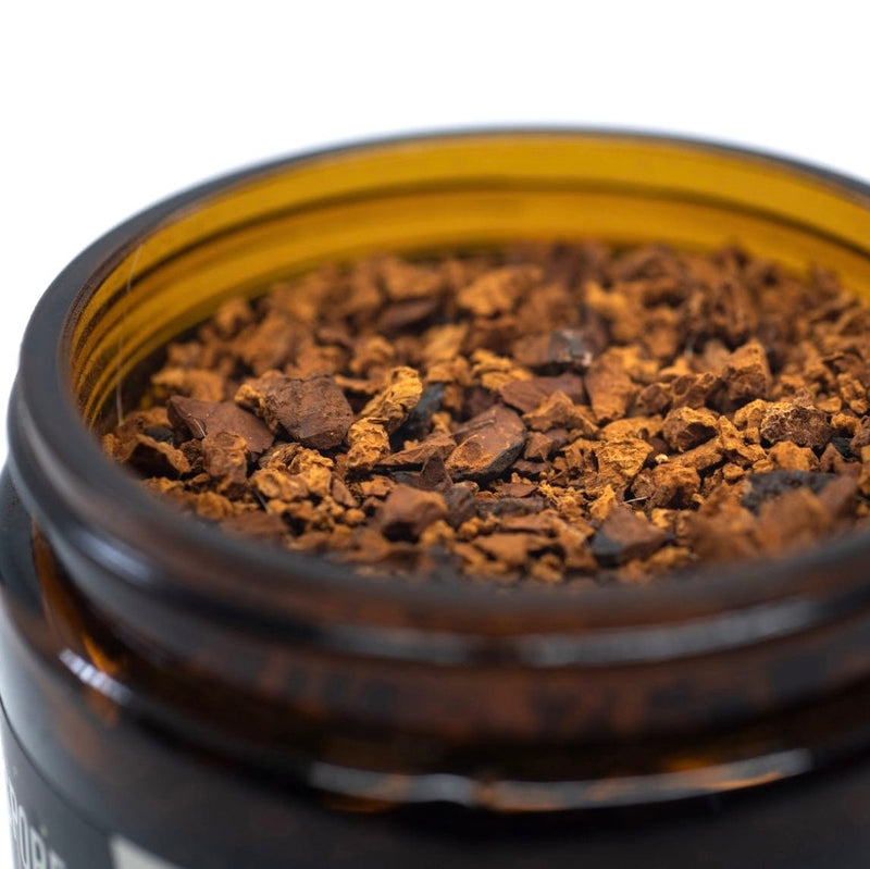 Close up of ground chaga mushroom wellness tea in jar